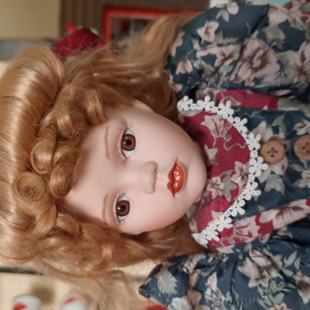 Beautiful porcelain doll with stand.